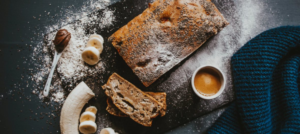 delicious chocolate cake with banana and coffee on table